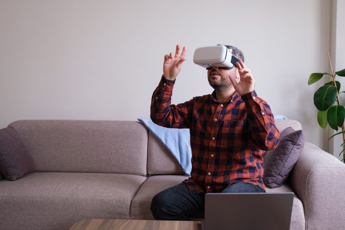 Man using virtual reality glass at home