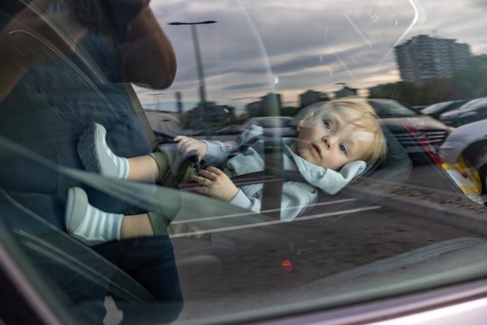 Little passenger relaxing in his car seat