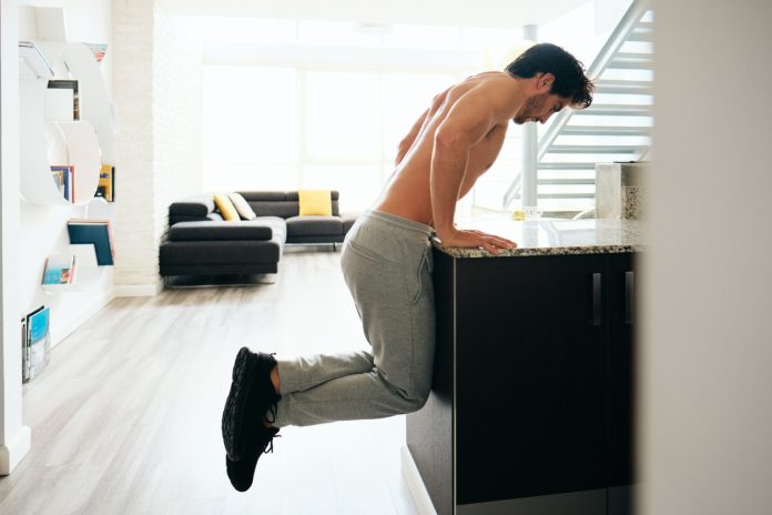Man Training Chest Doing Low Chest Push-Ups On Kitchen Counter