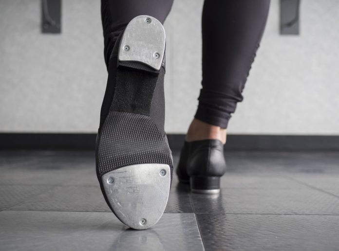 Toe Tap in Tap shoes with a back view