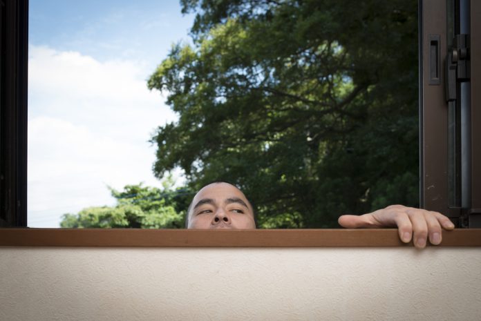 Suspicious person looking through the window