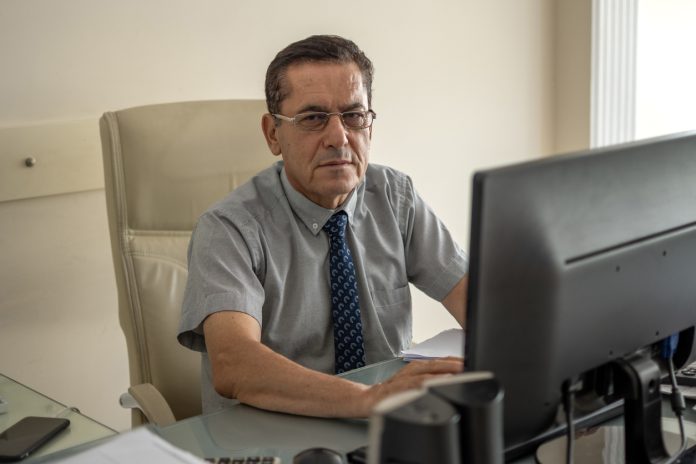 Mature man working to account office